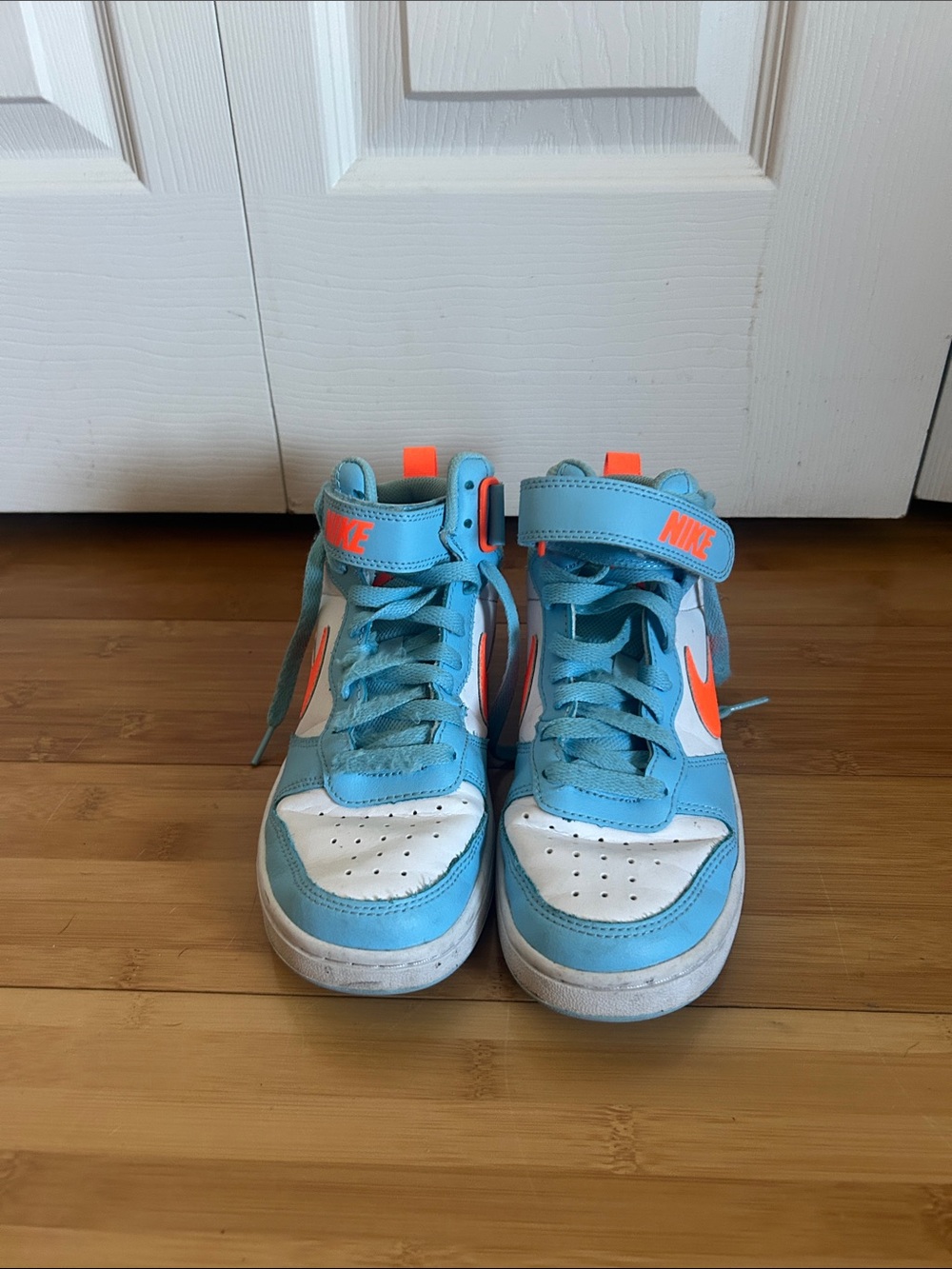 Nike Kids Light Blue and White High-Top Sneakers with Orange Swoosh